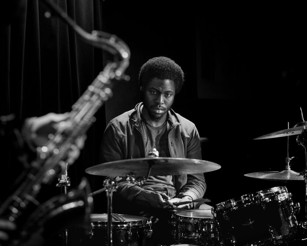 Black-And-White Musician Photograph Used As The Durham Jazz Festival Website Background.